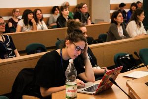 Woman taking notes at ExRe(y) Conference