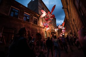 Art installation of illuminated fish lanterns above a street during Night of Culture festival in Lublin, Poland