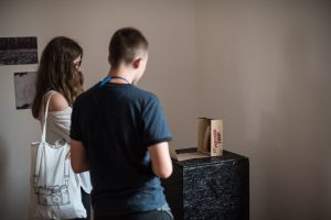 Woman and man looking at art display